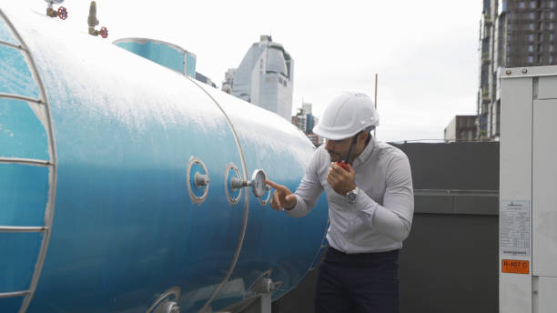 istock An engineer man or worker, people working in industry factory. Chiller tower on rooftop building. System work machine. Condenser Water Supply pipe lines. Ventilation compressor. Workshop site. 1408707510