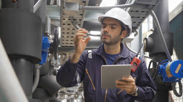 istock An engineer man or worker, people working in industry factory. Chiller tower on rooftop building. System work machine. Condenser Water Supply pipe lines. Ventilation compressor. Workshop site. 1408707641