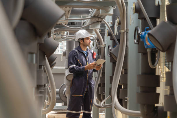 istock An engineer man or worker, people working in industry factory. Chiller tower on rooftop building. System work machine. Condenser Water Supply pipe lines. Ventilation compressor. Workshop site. 1408707687