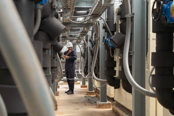 istock An engineer man or worker, people working in industry factory. Chiller tower on rooftop building. System work machine. Condenser Water Supply pipe lines. Ventilation compressor. Workshop site. 1408707752