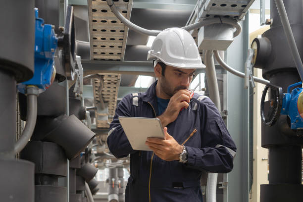 istock An engineer man or worker, people working in industry factory. Chiller tower on rooftop building. System work machine. Condenser Water Supply pipe lines. Ventilation compressor. Workshop site. 1408707793
