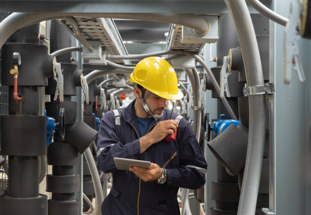 istock An engineer man or worker, people working in industry factory. Chiller tower on rooftop building. System work machine. Condenser Water Supply pipe lines. Ventilation compressor. Workshop site. 1408707813