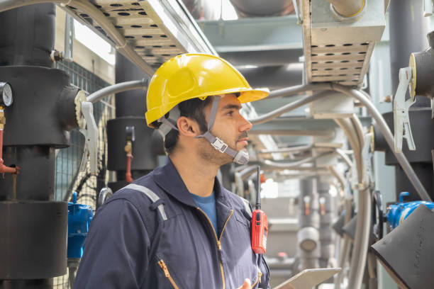 istock An engineer man or worker, people working in industry factory. Chiller tower on rooftop building. System work machine. Condenser Water Supply pipe lines. Ventilation compressor. Workshop site. 1408707898