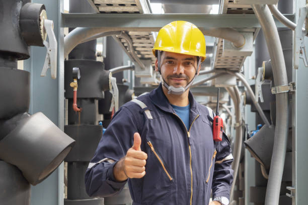 istock An engineer man or worker, people working in industry factory. Chiller tower on rooftop building. System work machine. Condenser Water Supply pipe lines. Ventilation compressor. Workshop site. 1408707903