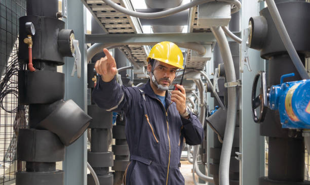 istock An engineer man or worker, people working in industry factory. Chiller tower on rooftop building. System work machine. Condenser Water Supply pipe lines. Ventilation compressor. Workshop site. 1408707936