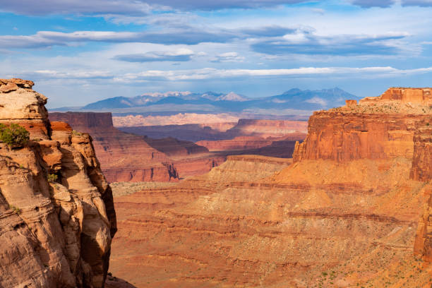 istock A deep canyon with red rock sandstone cliffs below a mountain range in southwest USA 1408709705