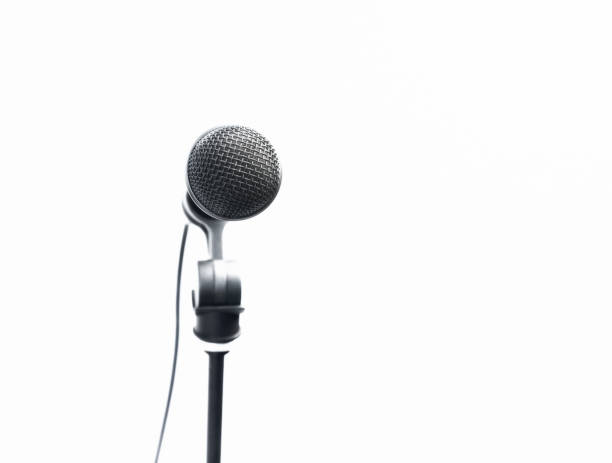 istock Vocal dynamic microphone, on a stand, in bright light on a white background with copy space 1408710841