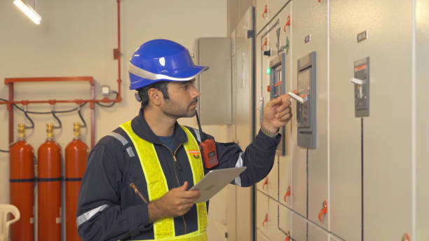 istock An engineer man or worker, people working in electrical room. Power energy motor machinery cabinets with panel in control or server room, operator station network in industry factory. Switchgear 1408716057