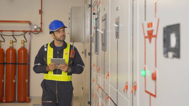 istock An engineer man or worker, people working in electrical room. Power energy motor machinery cabinets with panel in control or server room, operator station network in industry factory. Switchgear 1408716067