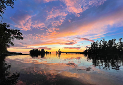 The sunrise over Burntside Lake, Ely Minnesota. Located in the Superior National Forest. Burntside Lake a popular tourist destination in the summer in Minnesota. Beautiful scenic area adjacent to the Boundary Water Canoe Area.