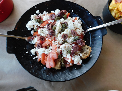 Tomato, rusk and feta cheese salad with caper and olives
