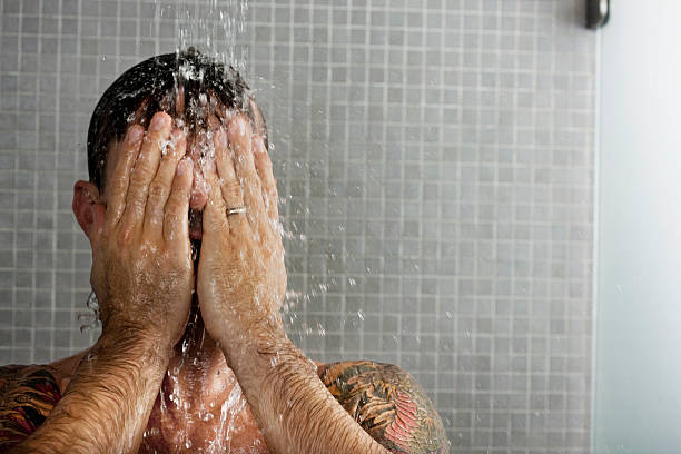 man washing his hair in shower - men naked shower bathroom ストックフォトと画像