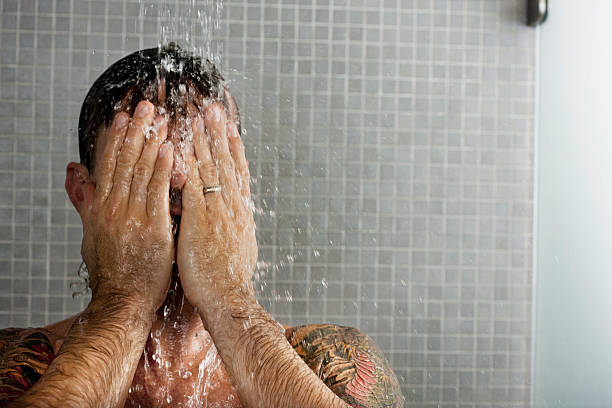 man washing his hair in shower - men naked shower bathroom 뉴스 사진 이미지