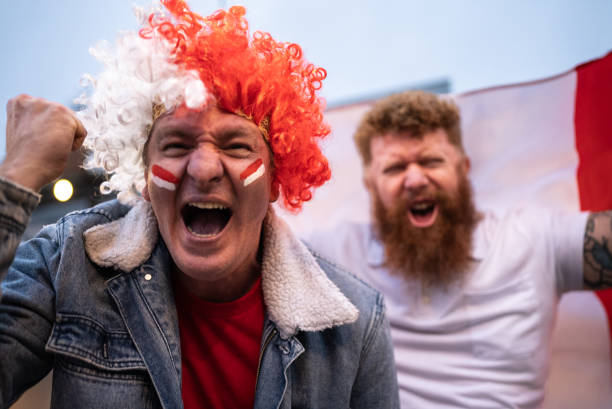 istock Mature men celebrating team scoring a goal outdoors 1408727399