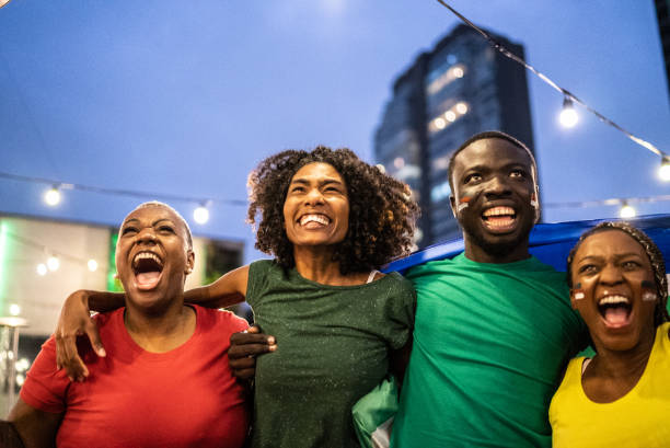 istock Friends celebrating team scoring a goal outdoors 1408727722
