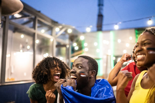 istock Friends celebrating team scoring a goal outdoors 1408727731