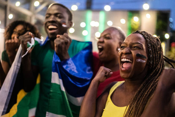 istock Friends celebrating team scoring a goal outdoors 1408727747
