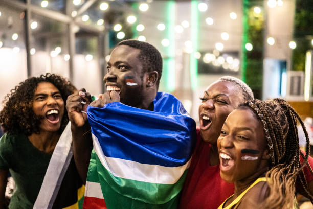 istock Friends celebrating team scoring a goal outdoors 1408727780