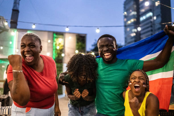 istock Friends celebrating team scoring a goal outdoors 1408727875