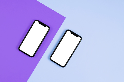 Mobile Phones on purple and blue background with copy space