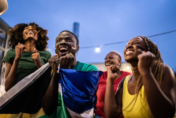 istock Friends celebrating team scoring a goal outdoors 1408728032