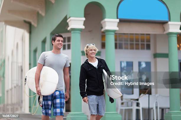 Teenage Boys Carrying Surfboards Stock Photo - Download Image Now - 16-17 Years, 18-19 Years, Adult