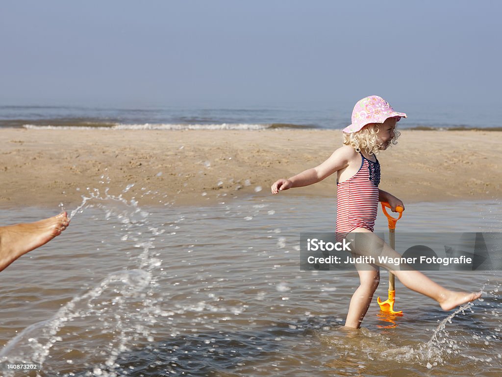 Child playing in water at beach  2-3 Years Stock Photo
