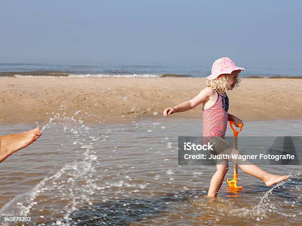 Child Playing In Water At Beach Stock Photo - Download Image Now - 2-3 Years, 40-44 Years, Adult