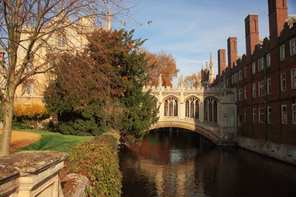 The famous Bridge of Sighs, St. John's College, Cambridge, England, from the Kitchen Bridge over the River Cam The Bridge of Sighs in Cambridge, England is a covered bridge at St John's College, Cambridge University. It was built in 1831 and crosses the River Cam between the college's Third Court and New Court.   It is a Grade I listed building, and one of Cambridge's main tourist attractions cambridge england stock pictures, royalty-free photos & images