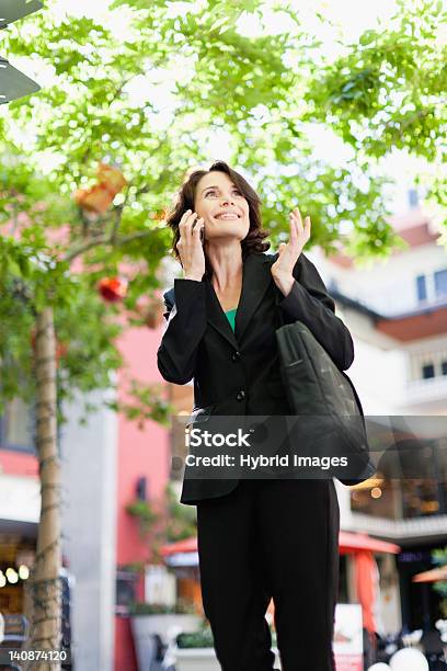 Businesswoman Talking On Cell Phone Stock Photo - Download Image Now - 40-44 Years, Adult, Adults Only