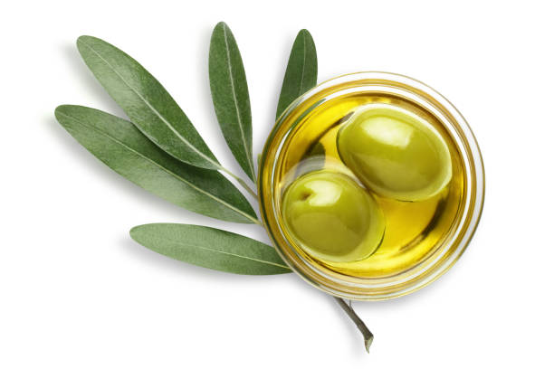 istock Two olives in oil with leaves on white 1408745888