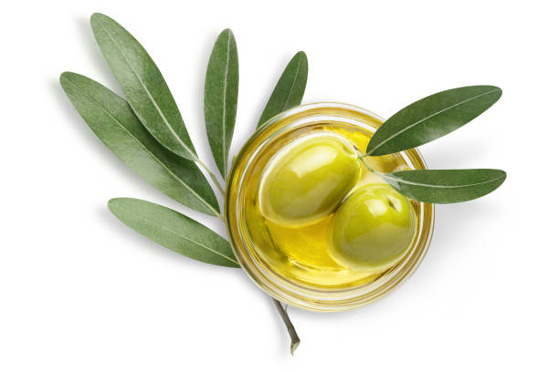 istock Two olives in oil with leaves on white 1408745919