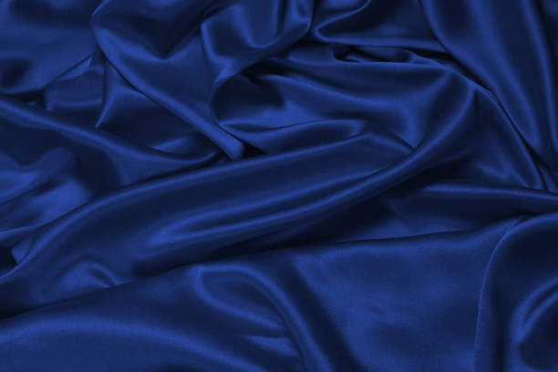 istock Rich and luxury red silk fabric texture background. 1408746619