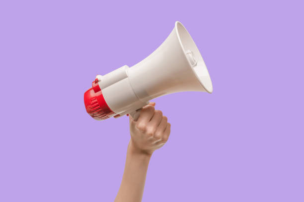 istock Megaphone in woman hands on a white background. 1408746634