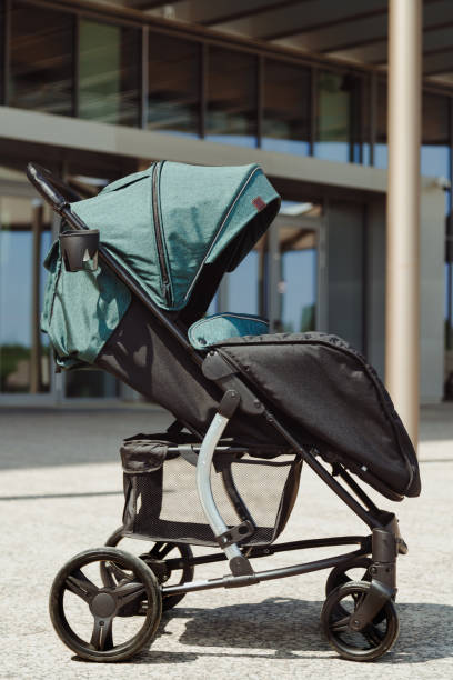 istock Modern contemporary green baby stroller outdoors side view 1408748972