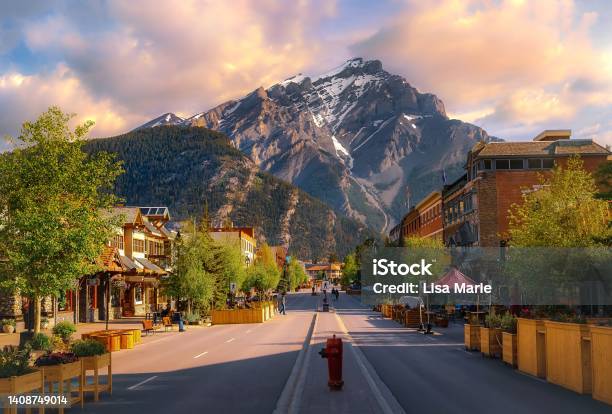 Sunrise Clouds Over A Mountain Road Through The Town Of Banff Stock Photo - Download Image Now
