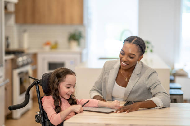istock Educational Assistant Working with a Cerebral Palsy Patient 1408749131