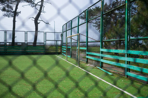 istock Soccer field in the countryside through net. 1408752413