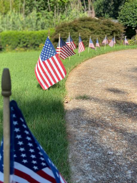 istock A row of American flags along a grassy walkway 1408752733