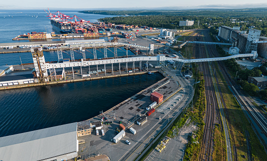 Aerial view of the marine leg of a grain elevator, shunting yard & container port in the distance.