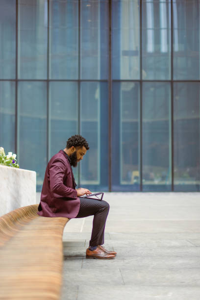 istock Black businessman checking e-mails in front of the office building 1408760702