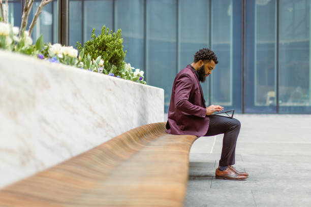 istock Black businessman checking e-mails in front of the office building 1408760704