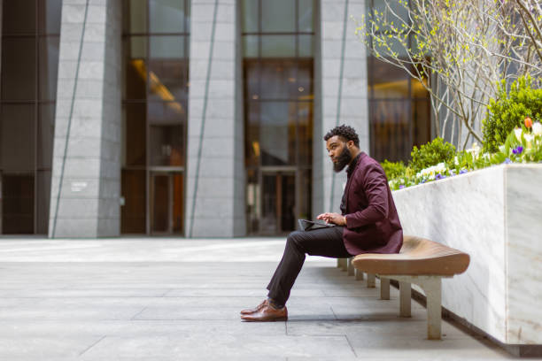 istock Black businessman checking e-mails in front of the office building 1408760708