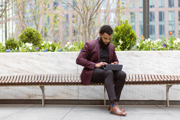 istock Black businessman checking e-mails in front of the office building 1408760850