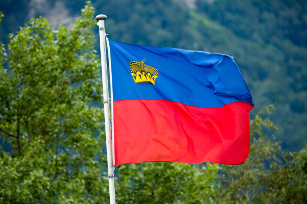 istock Flag of Liechtenstein on mountains background on summer 1408760869