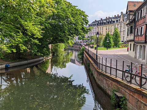 Restaurants and houses by canal locks along river in Colmar France