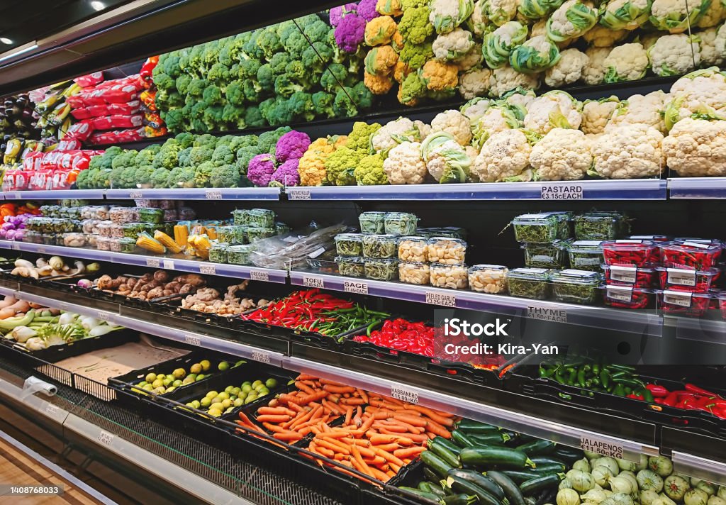Fruits and vegetables on shop stand in supermarket grocery store Fresh vegetable counter in supermarket. Fruits and vegetables on shop stand in supermarket grocery store Vegetable Stock Photo