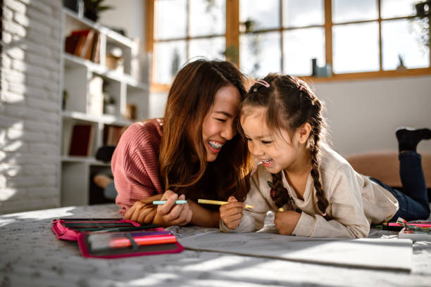 istock Mother and daughter having fun drawing together 1408769943