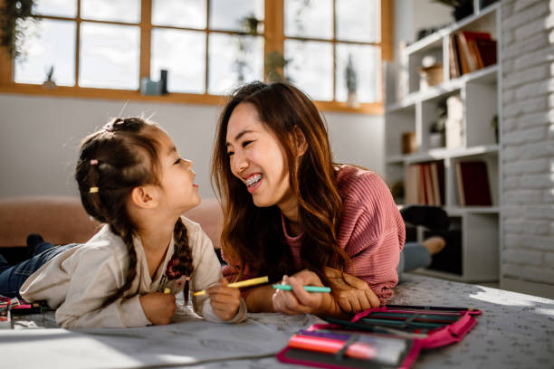 istock Mother and daughter having fun drawing together 1408769951