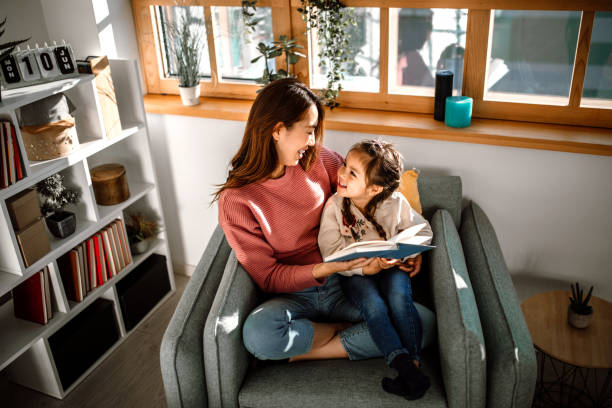 istock Mother and little daughter reading book together 1408770164